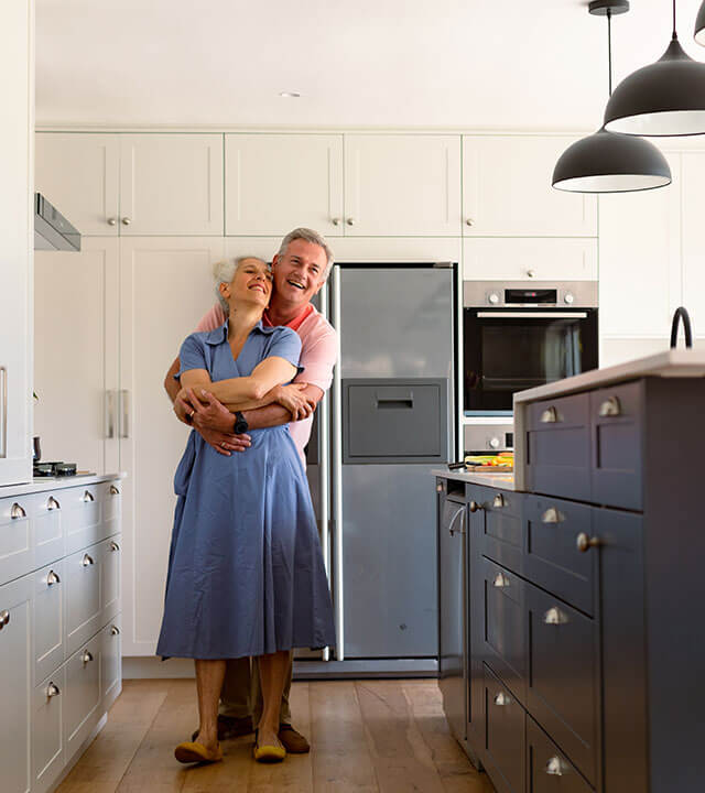older couple dancing in newly painted kitchen